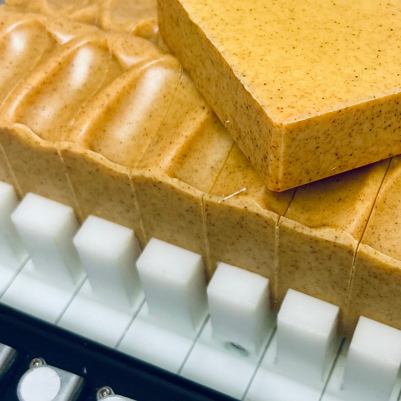 Close-up of turmeric soap bars on a white tray