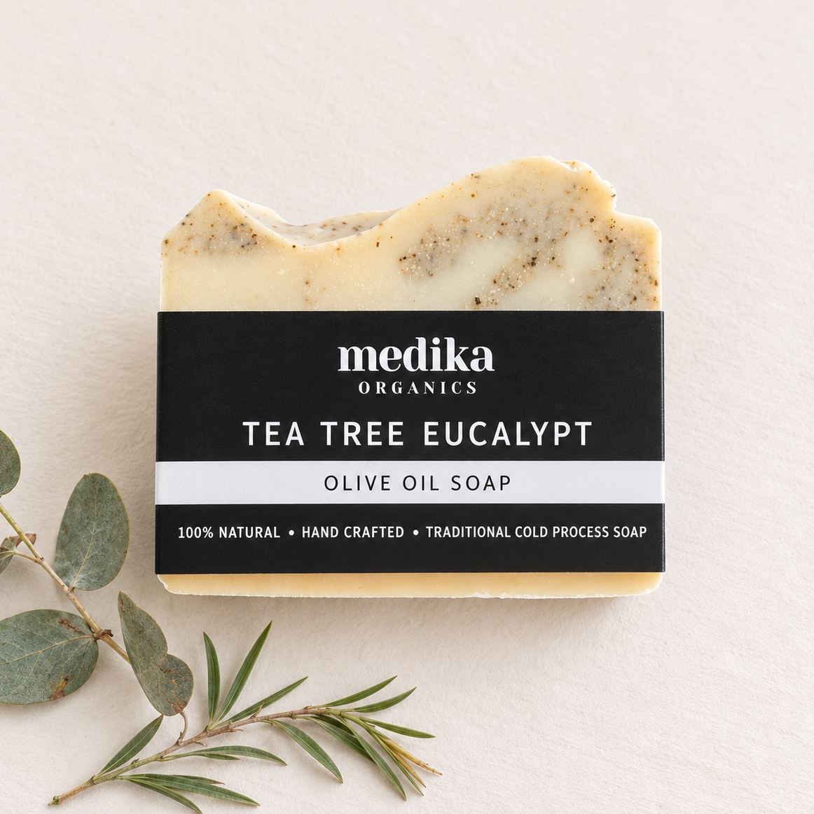Handmade tea tree and eucalyptus soap surrounded by natural botanicals. Australian cold process soap with a clean, minimalist style.