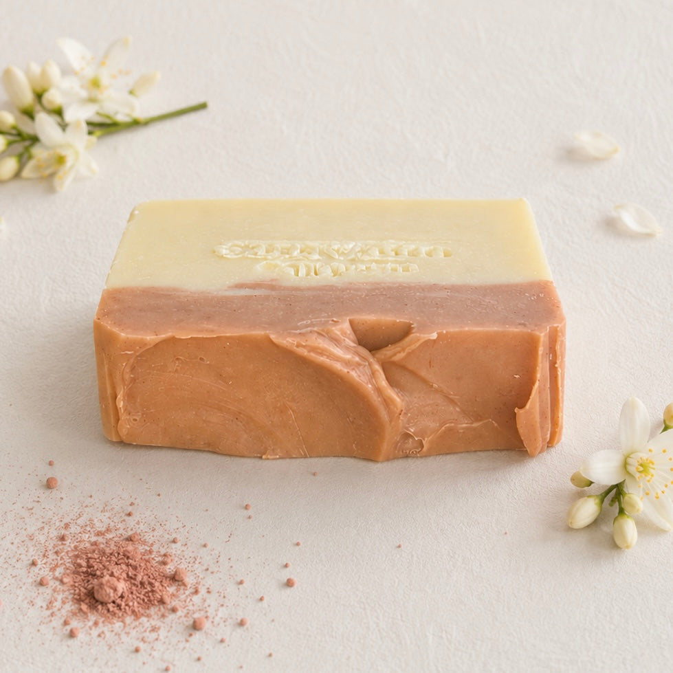 A rectangular bar of handmade soap with a two-tone design, featuring a pale cream top half and a warm peachy-brown bottom half. The brand name 'Medika Organics' is embossed on the top.