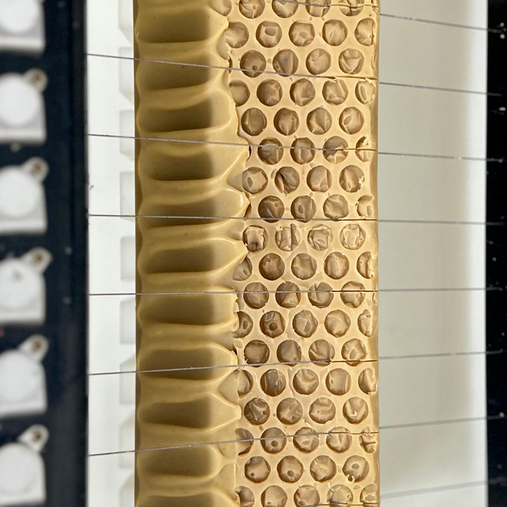 Close-up of a textured tan honeycomb-patterned soap top.