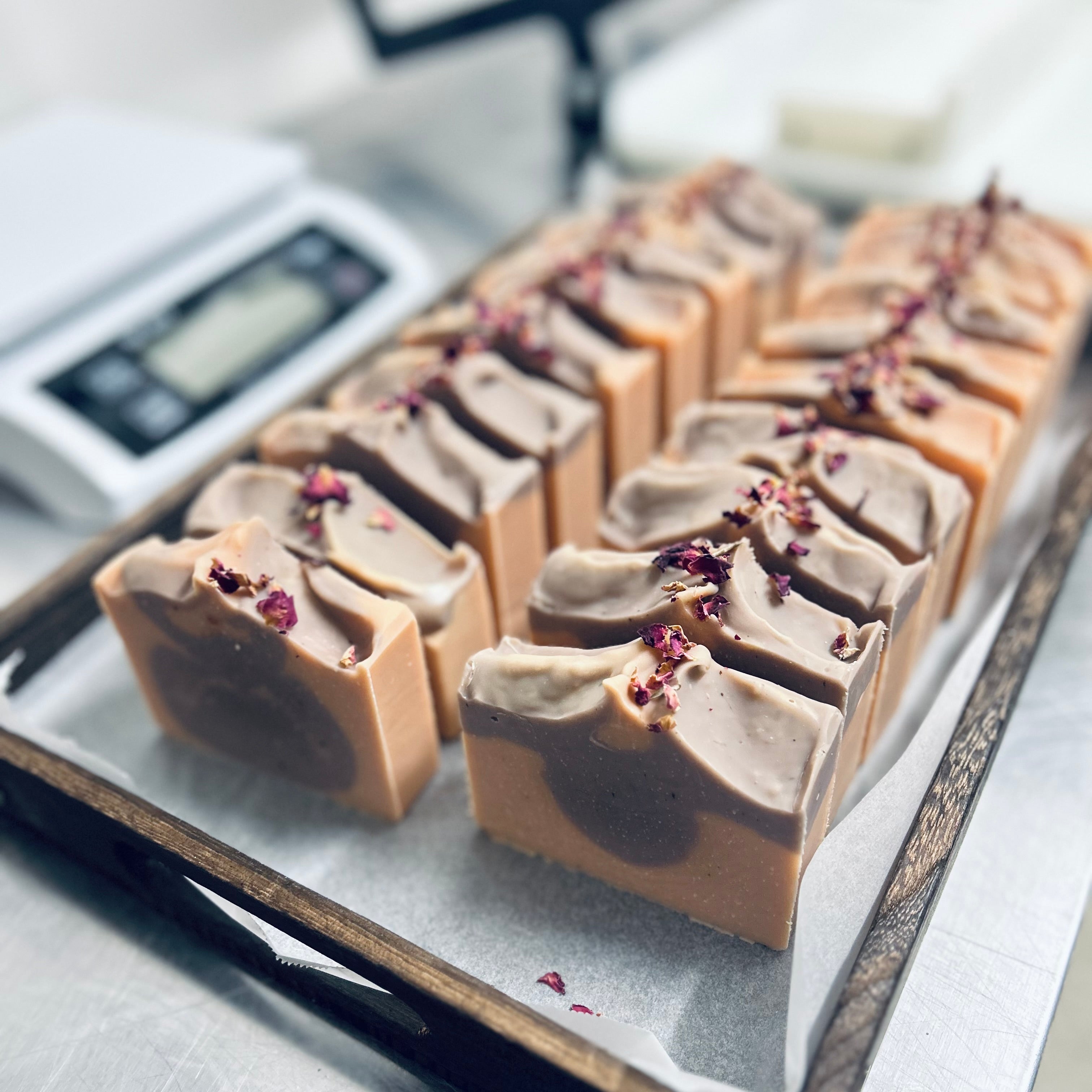 Handcrafted rectangular soap bars with pink and purple clay swirl pattern, topped with dried rose petals. Rose Patchouli Organic Soap made by Medika Organics Australia